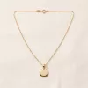 Soleil Medallion Necklace laid flat on linen: polished gold disc on a fine cable chain