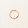 Slim polished gold band on linen