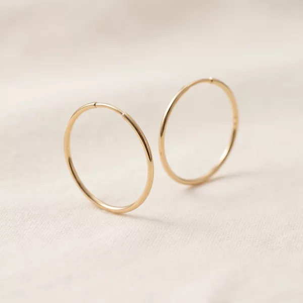 Fine gold hoop earrings, side view