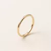 Slim polished gold band, angled view