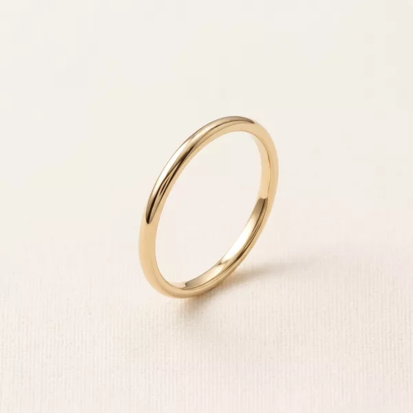 Slim polished gold band, angled view